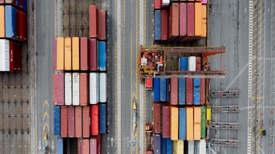 Stacked shipping containers at a major port showing the scale of global trade dependency