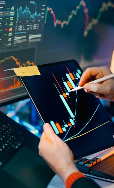 Trader analyzing cryptocurrency charts on multiple screens