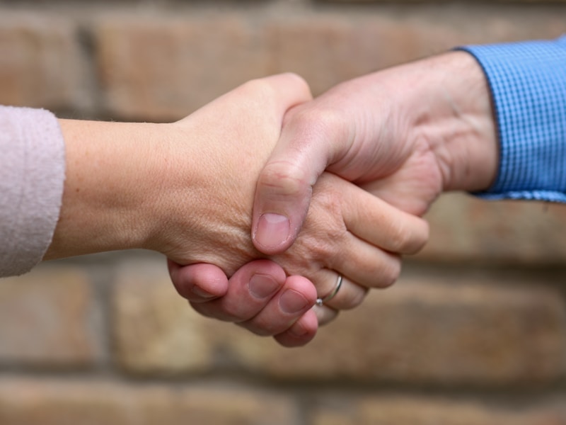 Business professionals shaking hands closing deal