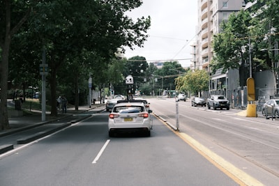 Autonomous vehicle driving through city streets with tall buildings